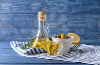 Tasty olive oil on wooden table�