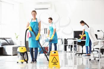 Team of janitors cleaning office�