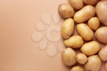Raw potato on color background�