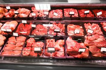 Refrigerated display case with fresh meat in supermarket�