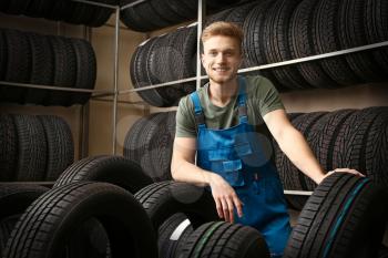 Male seller in car tire store�