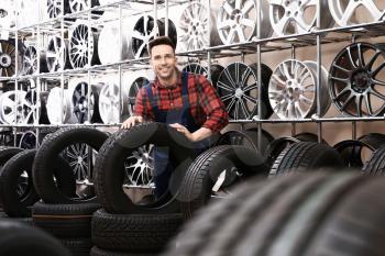 Male seller in car tire store�