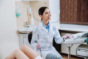 Female doctor conducting ultrasound examination of woman in clinic�