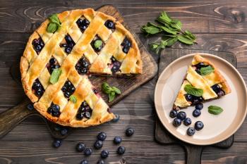Tasty blueberry pie on wooden table�