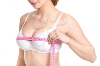 Young woman measuring her breast on white background�