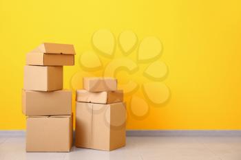 Cardboard boxes near color wall�