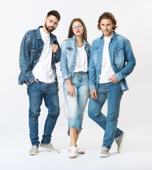 Stylish young people in jeans clothes on white background�