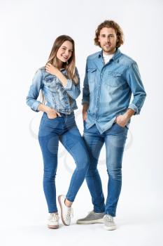 Stylish young couple in jeans clothes on white background�
