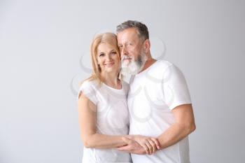 Beautiful elderly couple on light background�