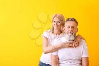 Beautiful elderly couple on color background�
