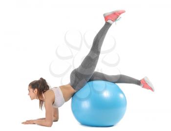 Young sporty woman doing exercises with fitball on white background�