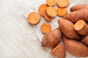 Raw sweet potato on light background�
