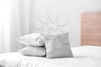 Soft pillows on cozy bed�