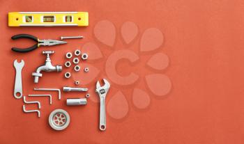 Set of plumbing tools and items on color background�