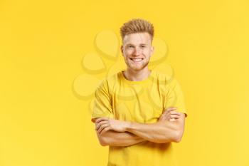 Portrait of handsome young man on color background�