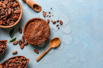 Composition with cocoa powder and beans on color background�
