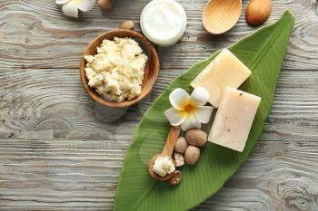 Composition with shea butter on wooden background�