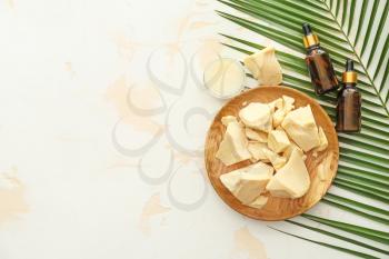 Composition with cocoa butter and cosmetics on light background�