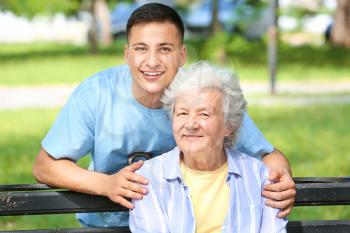 Grandson with senior woman in park�