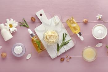 Composition with shea butter and cosmetics on table�