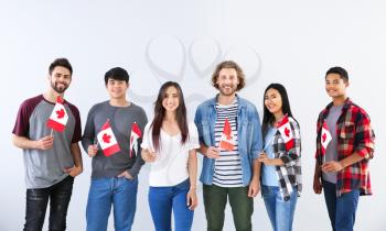 Group of students with Canadian flags on light background�