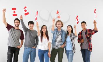 Group of students with Canadian flags on light background�