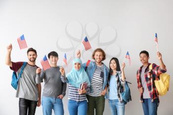 Group of students with USA flags on light background�