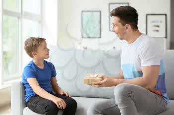 Little boy greeting his dad with Father's Day at home�