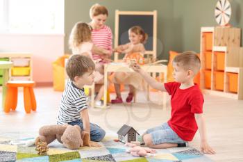 Cute little children playing in kindergarten�