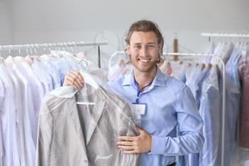 Handsome male worker in modern dry-cleaner's�