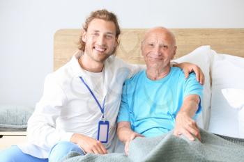 Doctor with elderly man in nursing home�