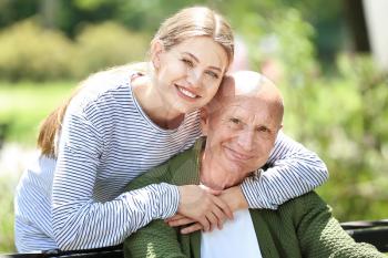 Elderly man with his daughter in park�