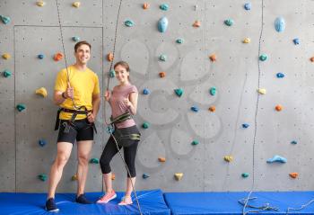 Young man and woman in climbing gym�