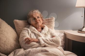 Senior woman suffering from insomnia at night�