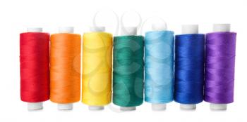 Colorful sewing threads on white background�