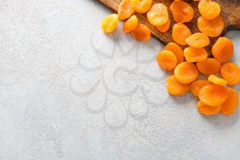 Tasty dried apricots on light background�