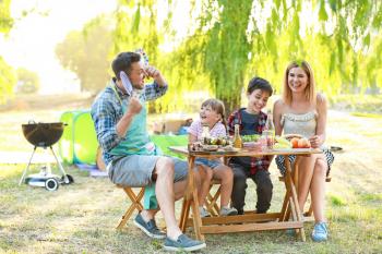 Happy family having picnic on summer day�