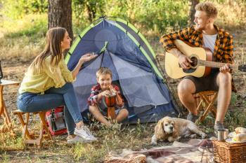 Happy family spending weekend in forest�