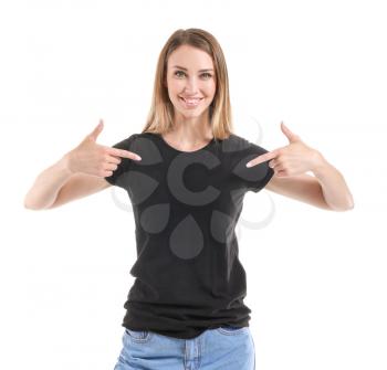 Woman pointing at her t-shirt against white background�
