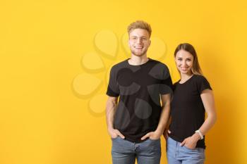 Couple in stylish t-shirts on color background�