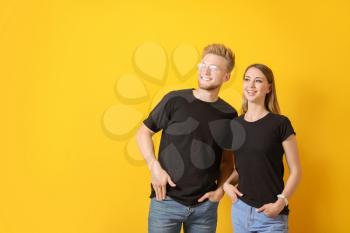 Couple in stylish t-shirts on color background�