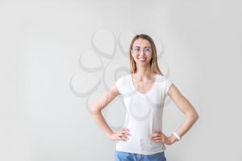 Woman in stylish t-shirt on light background�