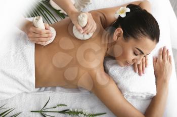 Beautiful young woman receiving massage in spa salon�