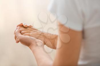 Young daughter calming elderly mother, closeup�