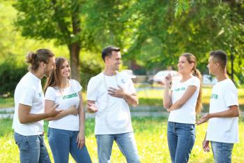 Team of volunteers outdoors on summer day�