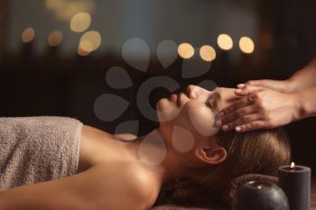 Beautiful young woman receiving facial massage in spa salon�