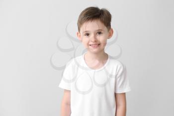 Little boy in stylish t-shirt on light background�