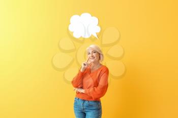 Stylish mature woman with blank speech bubble on color background�