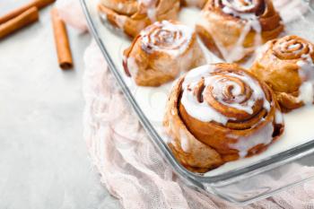 Baking tray with tasty cinnamon buns on table�