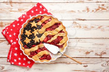 Tasty American flag pie on wooden background�